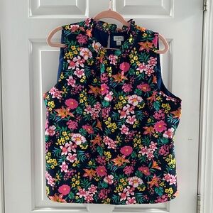 Summer sleeveless top in floral print on a very dark blue background.